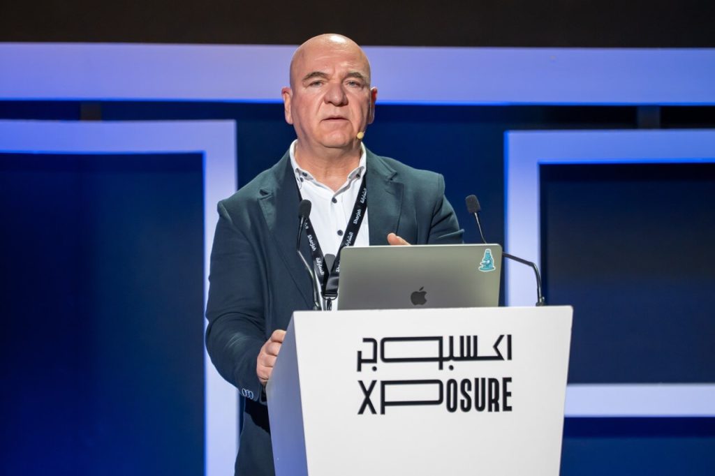 Alp Can during a talk titled A Photographic Odyssey Rise Fall of Corals Reefs